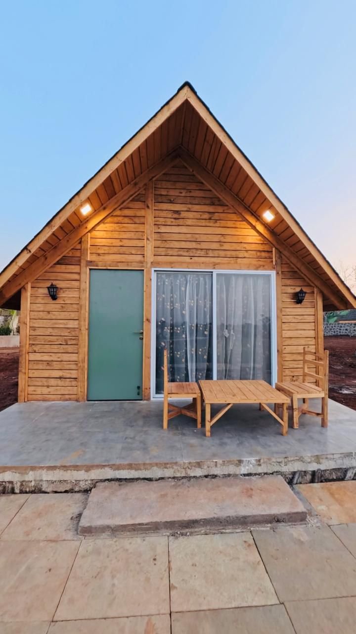 Karibu Resort aerial view of wooden log houses surrounded by lush greenery